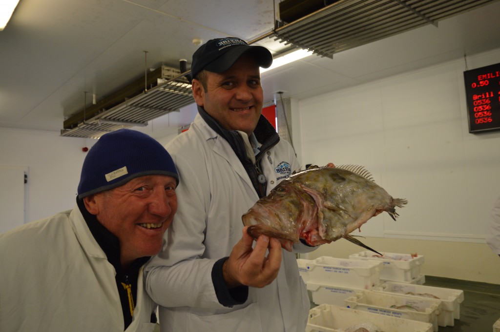 Barry Young (R) at Brixham Fish Market with one of the fishermen and a John Dory. 