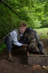Angus Buchanan Smith with one of the pigs enjoying the spoils of EnRoot's activities.