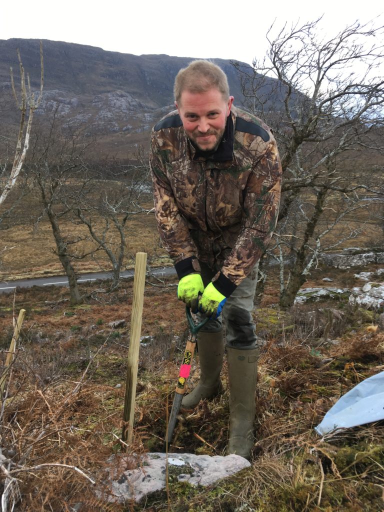 Niall planting organic trees. 